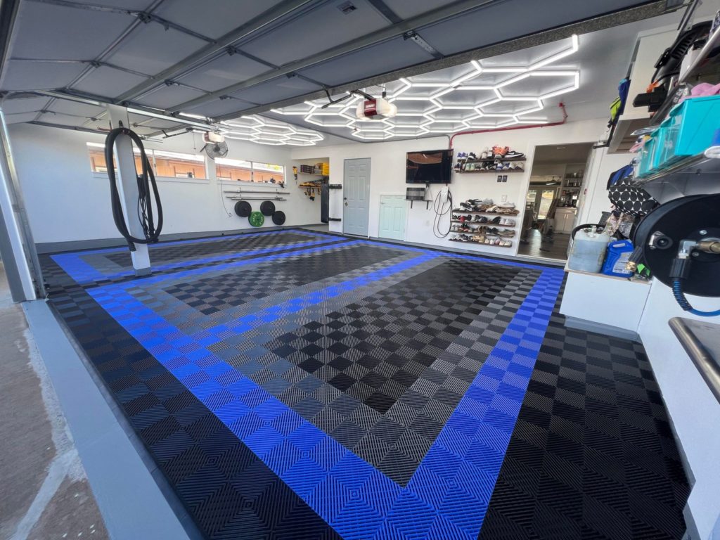 3-car garage with RaceDeck FreeFlow modular flooring in black, blue, and graphite, a better alternative to epoxy in Hawaii.
